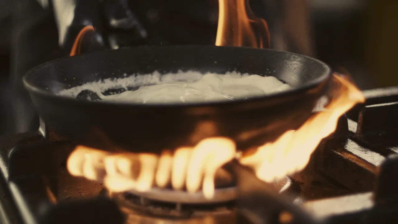 Lågor runt en panna i köket